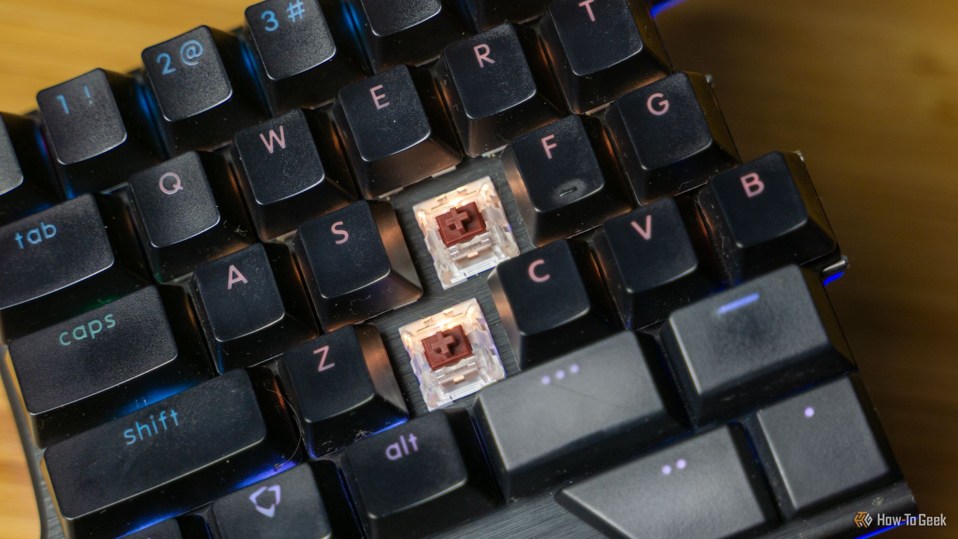 The Dygma Raise keyboard with a few keycaps removed to show its how-swappable switches.