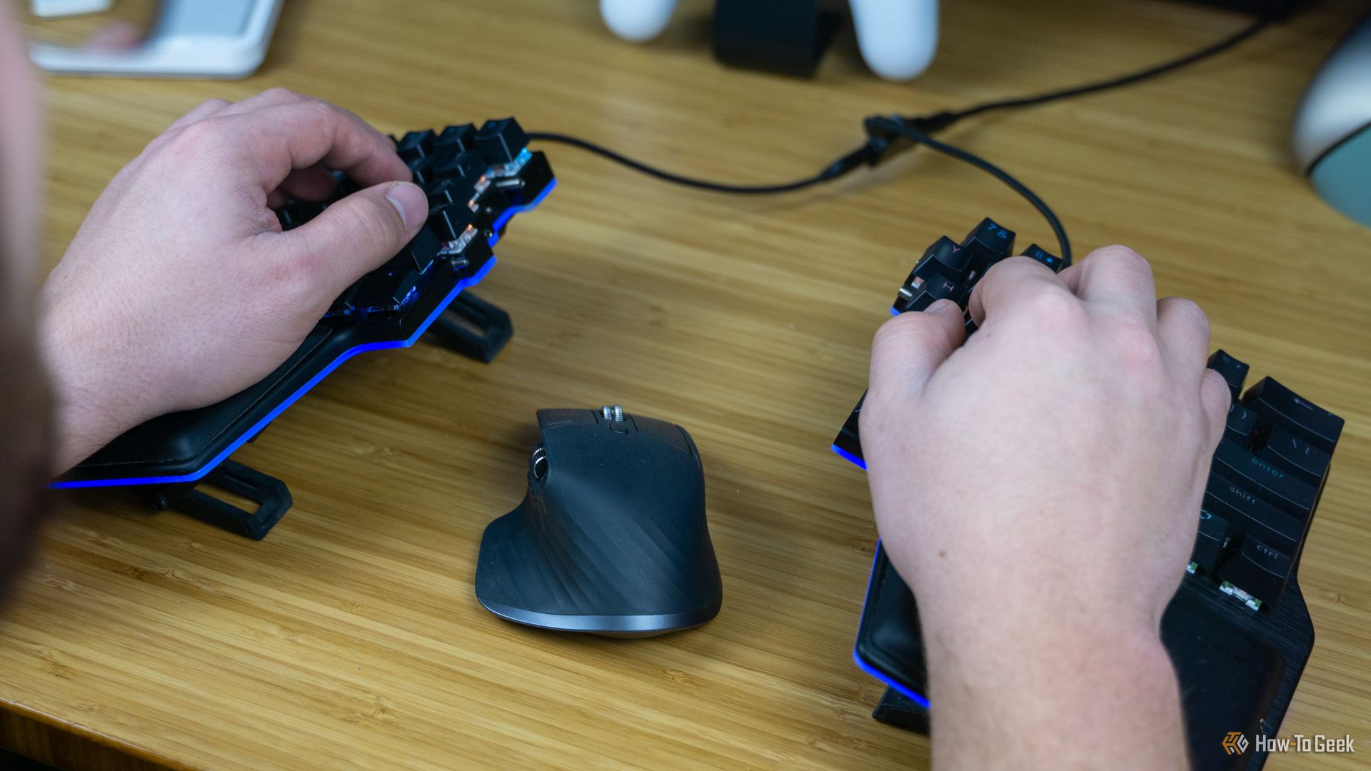 A person's hands sitting on the Dygma Raise keyboard to show how ergonomic it is.