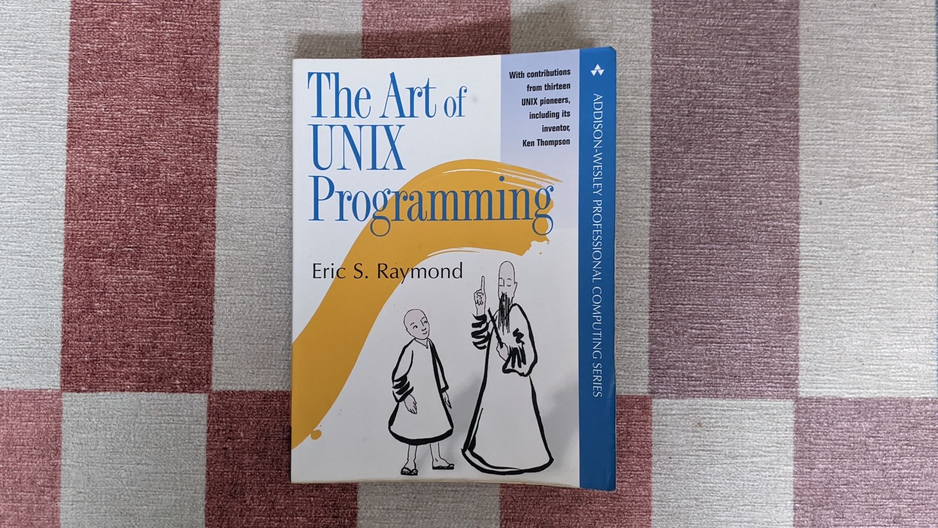 The front cover of The Art of UNIX Programming shows a wise old master explaining something to a young pupil.