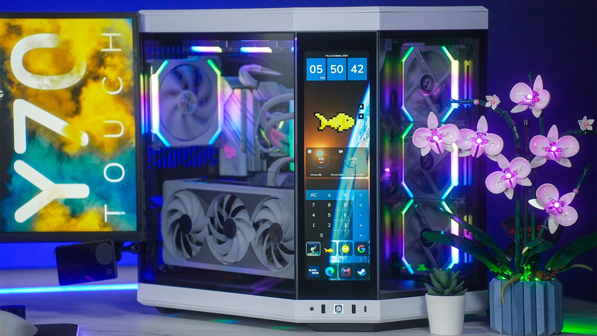 The HYTE Y70 Touch PC case featuring a built-in touchscreen sitting on a white desk.