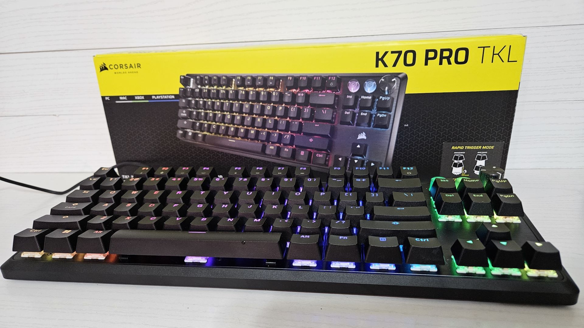 The Corsair K70 PRO TKL Keyboard in front of its package on a white background.