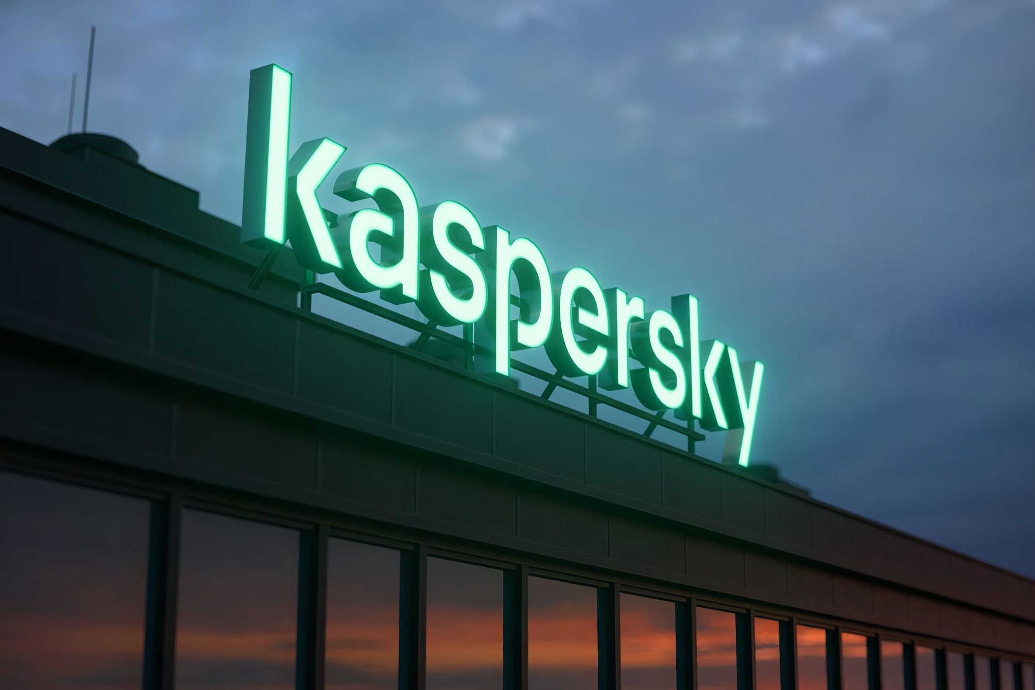 Closeup of a building's top with a Kaspersky neon sign