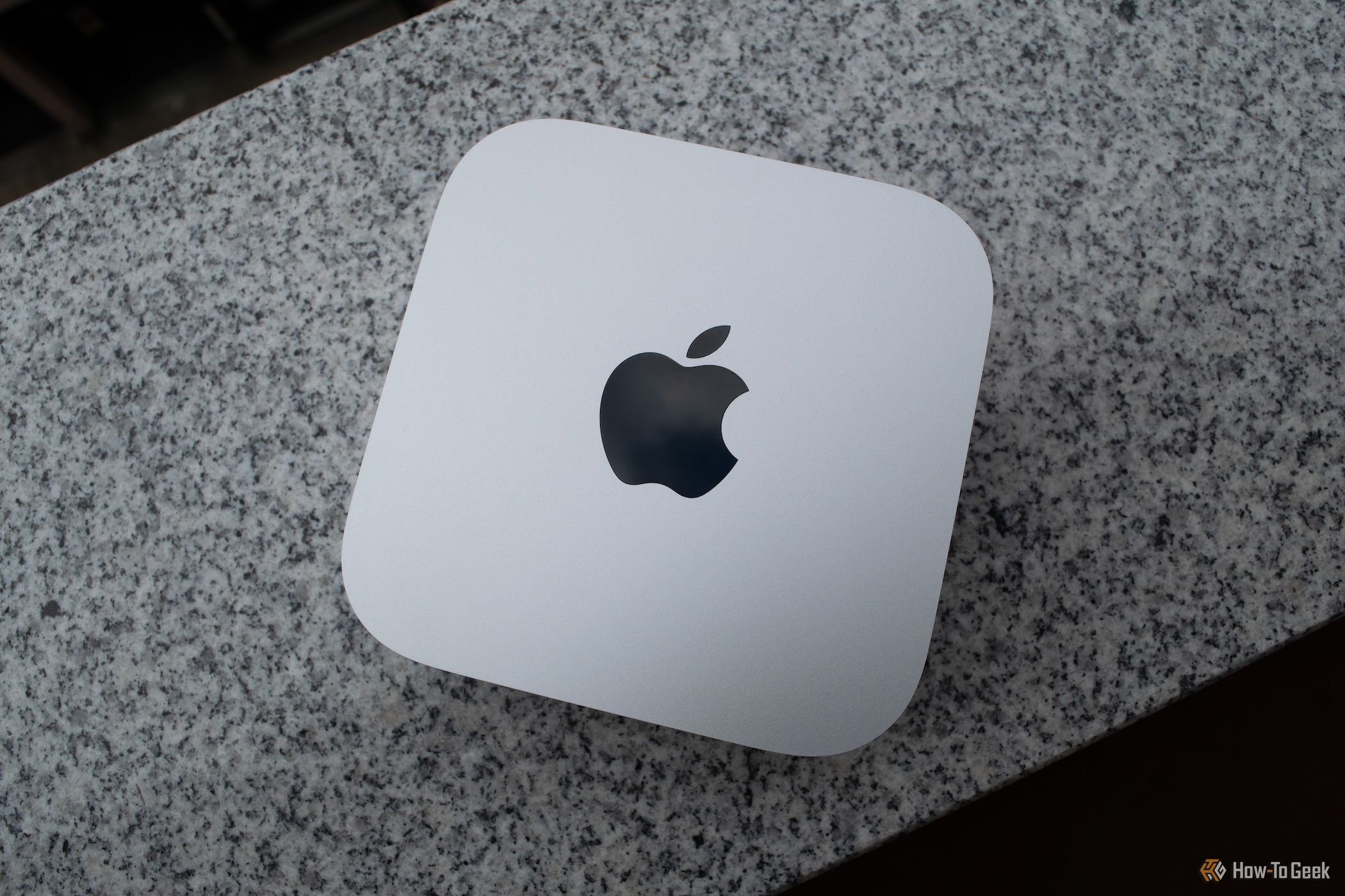 An M4 Mac Mini sitting on a granite countertop.