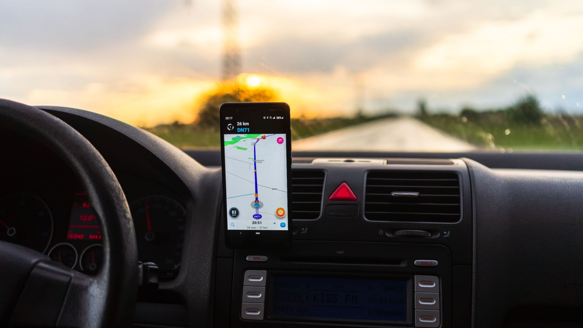 An Android smartphone in a cradle attached to car dashboard, displaying a navigation app.