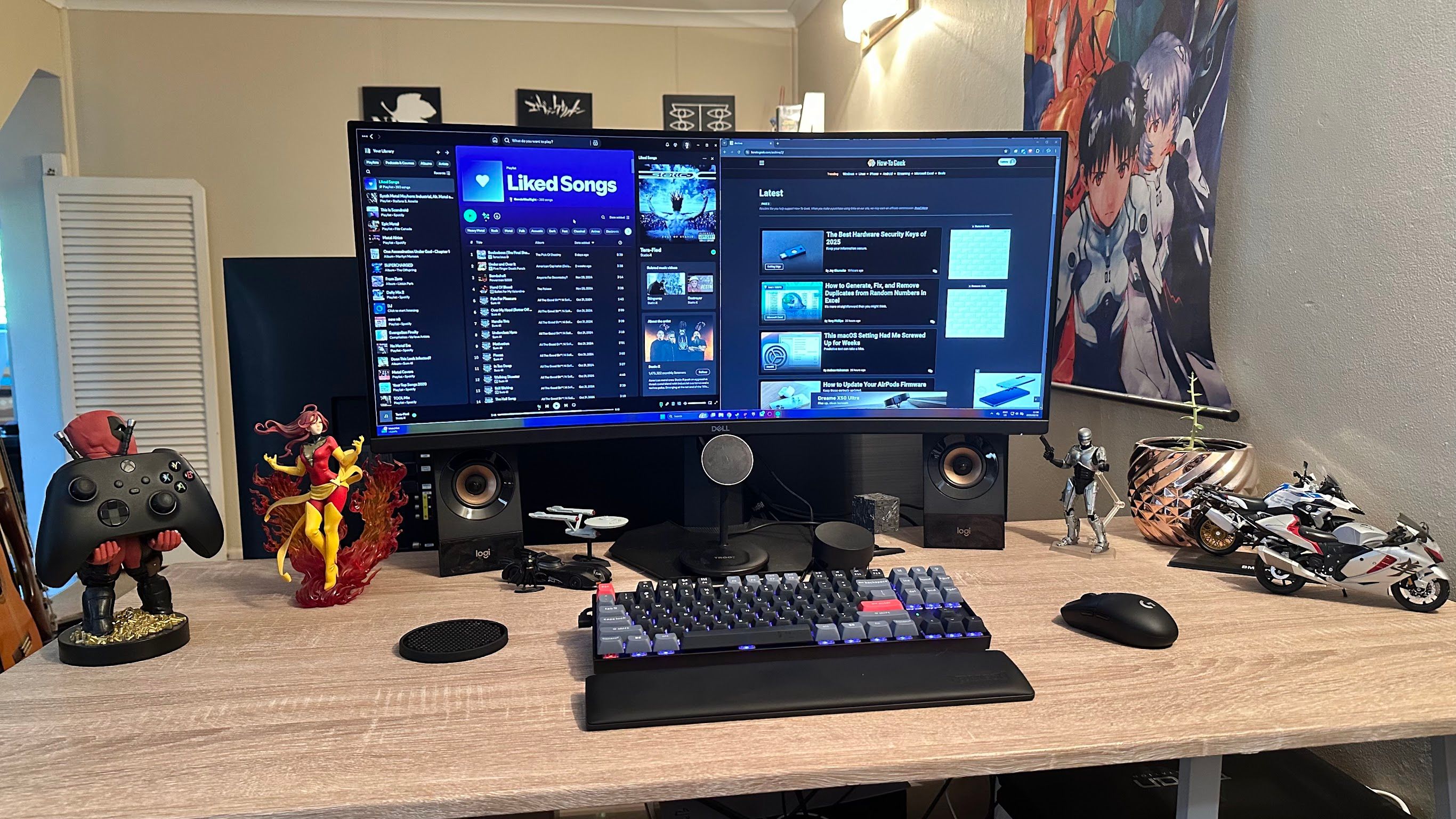 Sydney's desktop setup with an ultrawide screen and some decorative figures. A closed laptop is visible at the bottom right of the image.