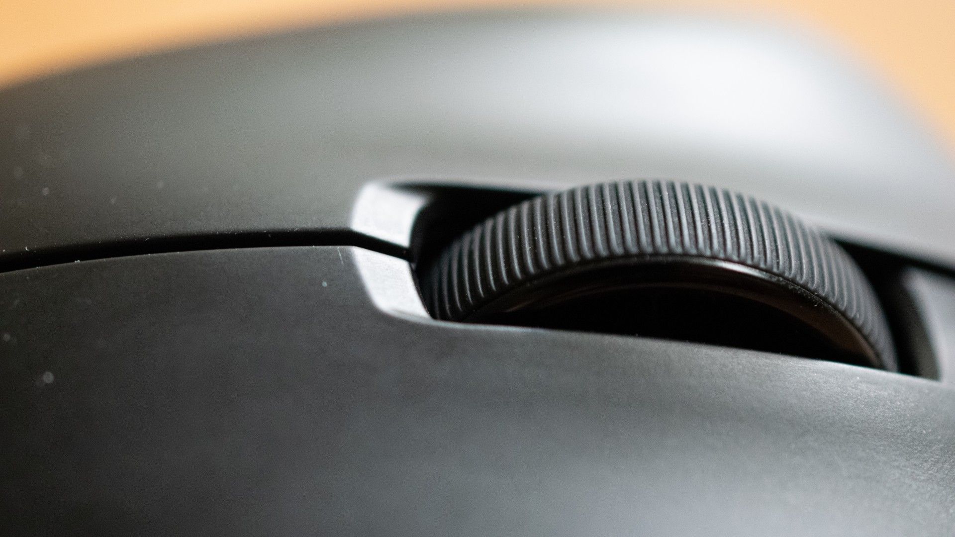 A closeup shot showing the scroll wheel of a Pulsar Xlite V3 gaming mouse.