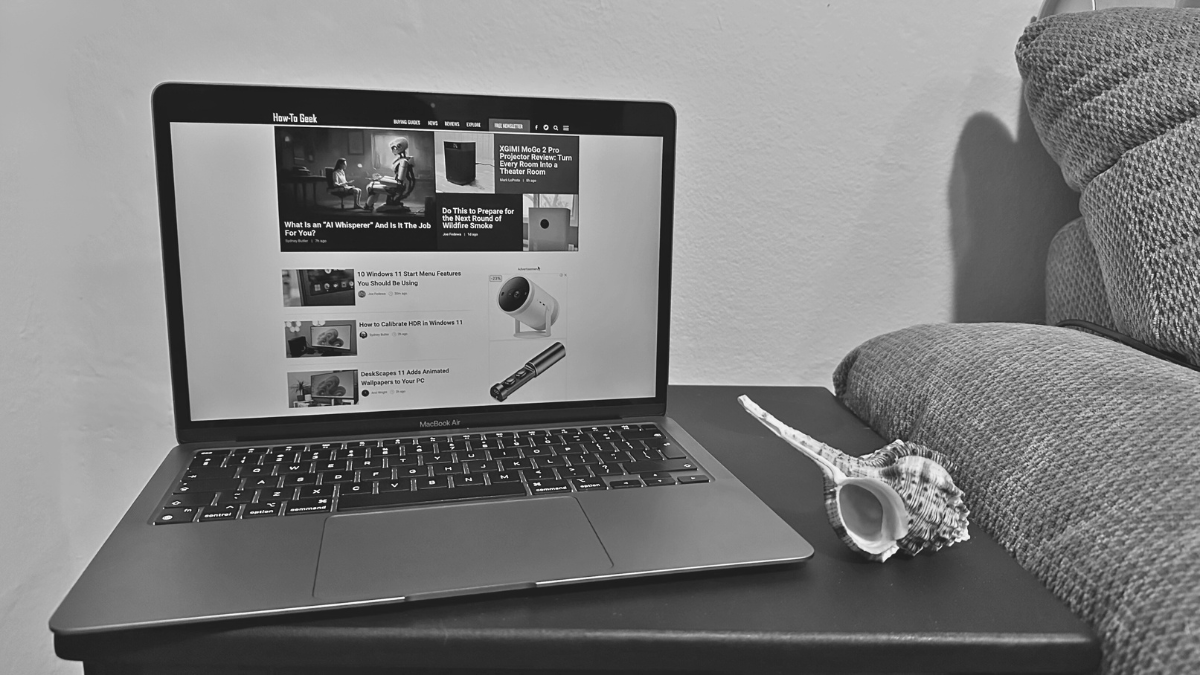 Sydney's M1 MacBook Air on a side table with a seashell.