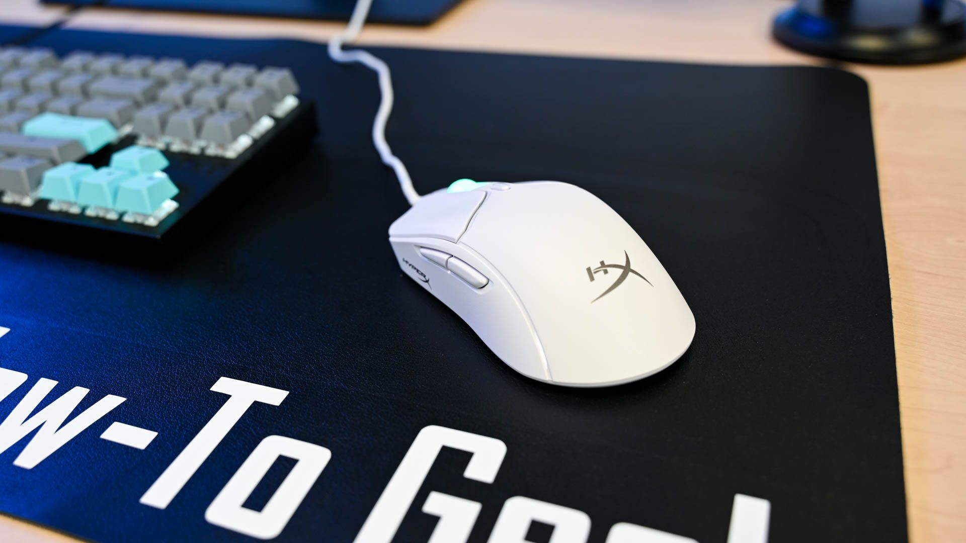 Angled view of the HyperX Haste 2 Gaming Mouse on a desk pad.