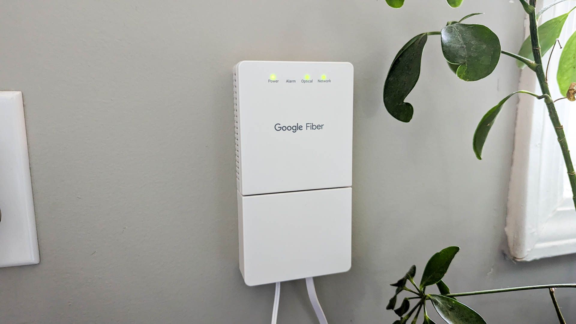 A Google Fiber modem mounted to the wall