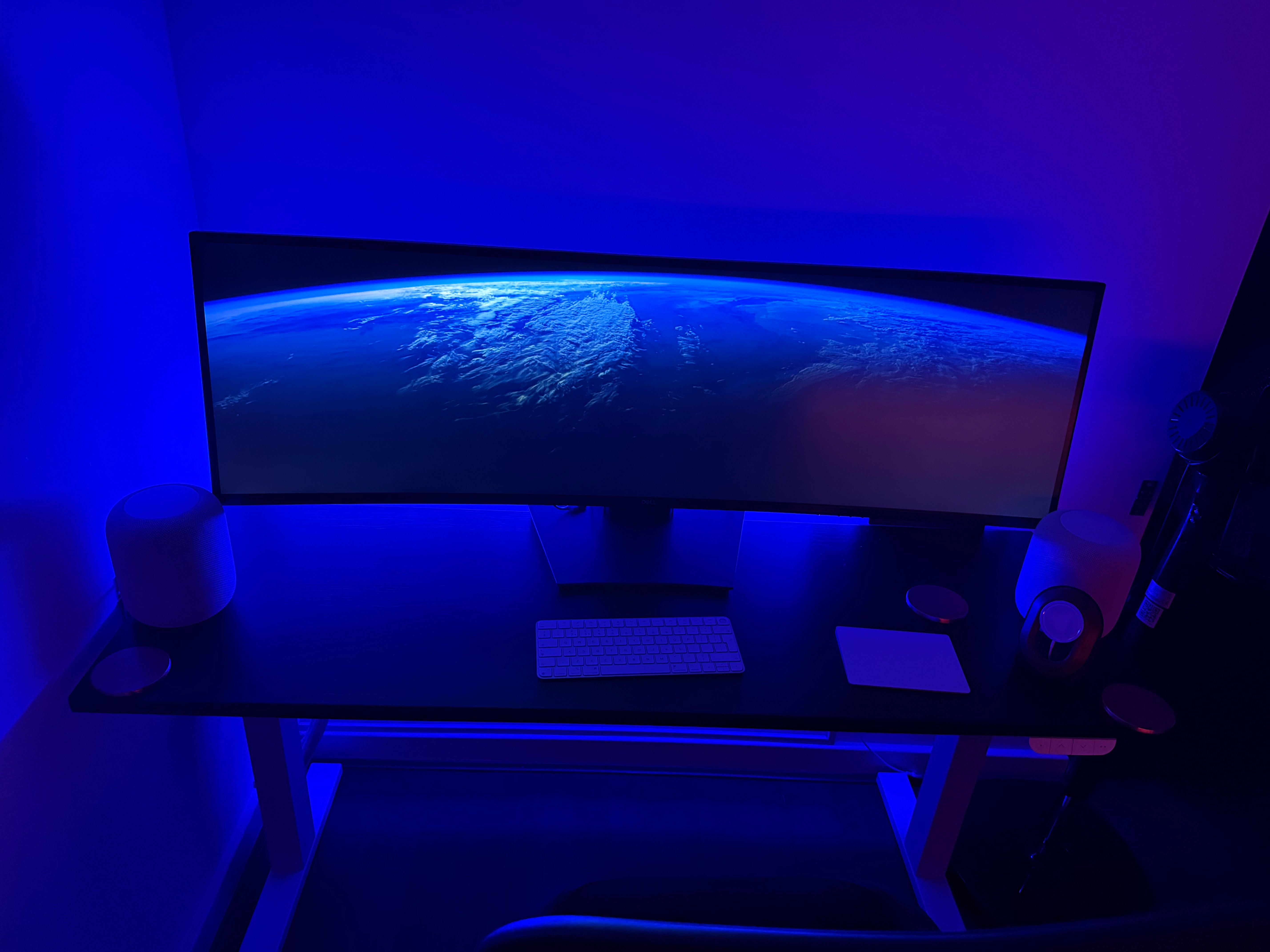 A home office with a Philips Hue striplight at the rear of the desk for a modern cool blue look.