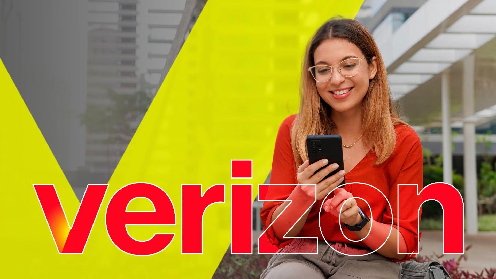 a-woman-sitting-on-a-bench-using-her-smartphone-with-the-verizon-logo-in-the-center