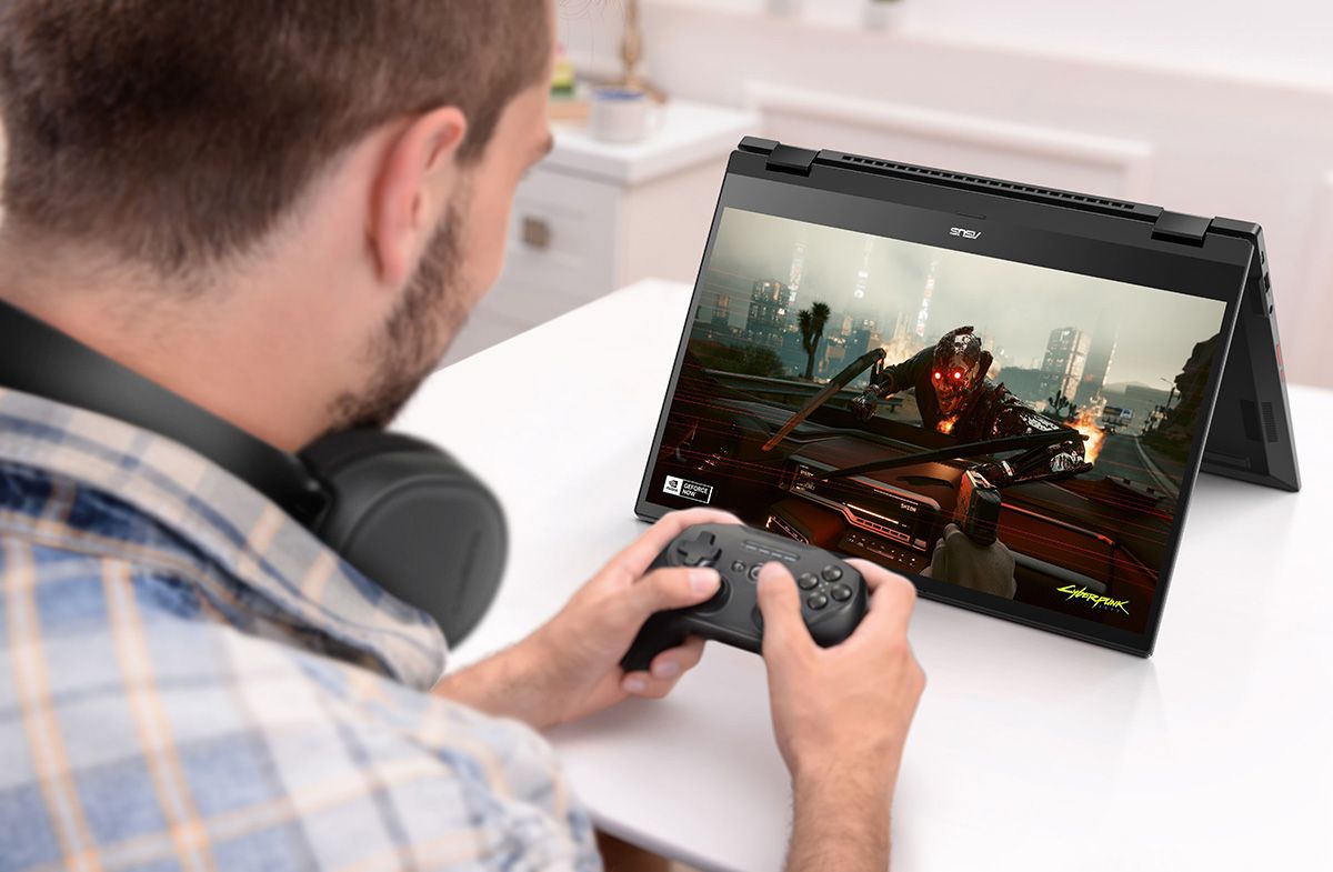 A person playing a game on an ASUS Chromebook Flip CX5 flipped into tent mode.