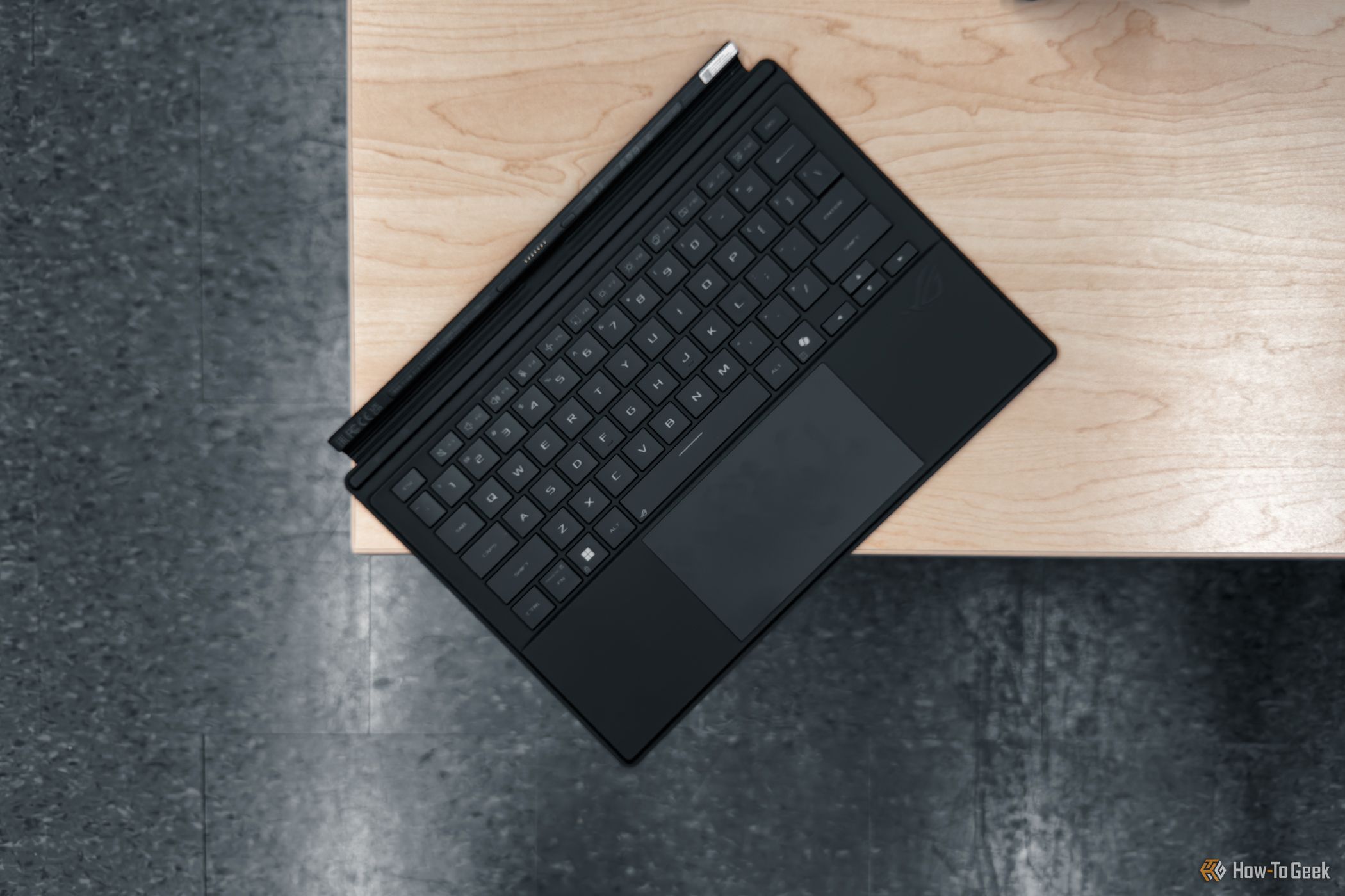 ASUS ROG Flow Z13 keyboard cover on wooden table.