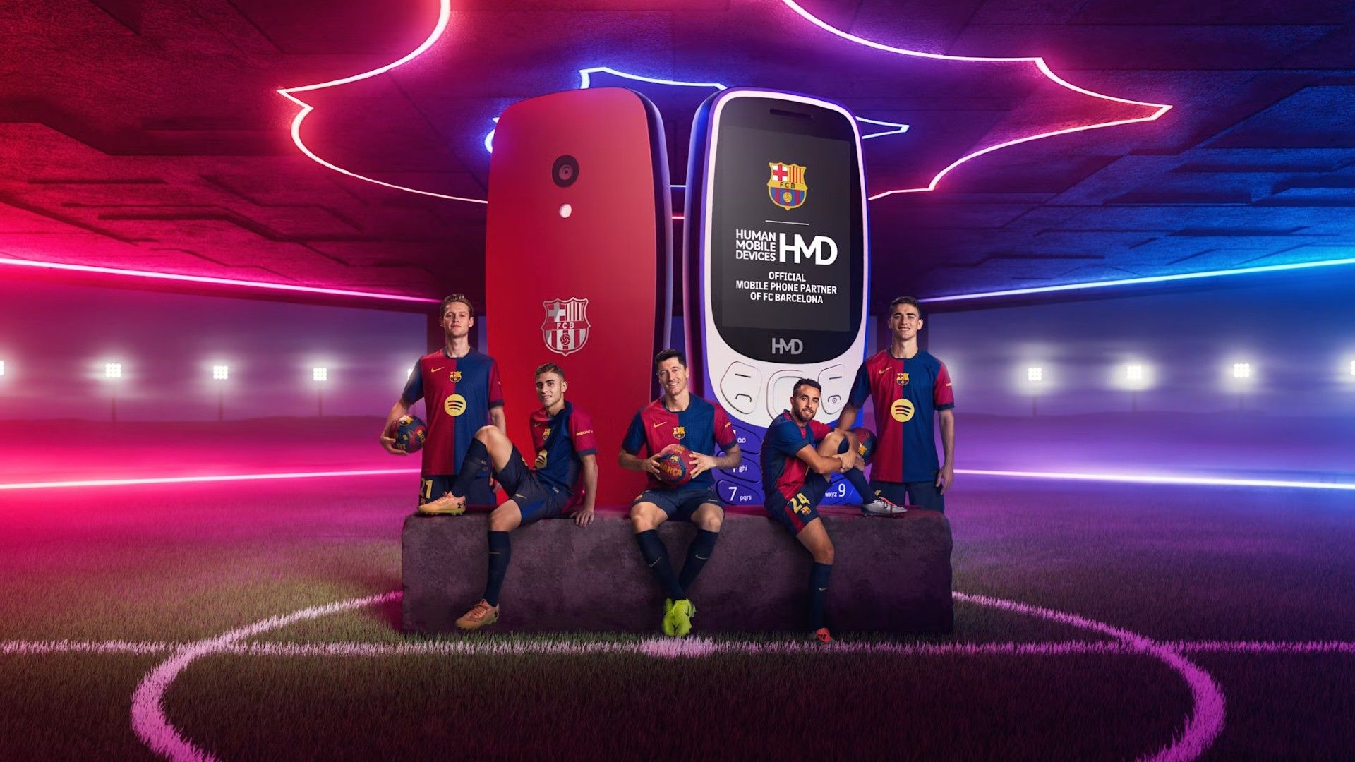 Barcelona players posing in front of two HMD phones