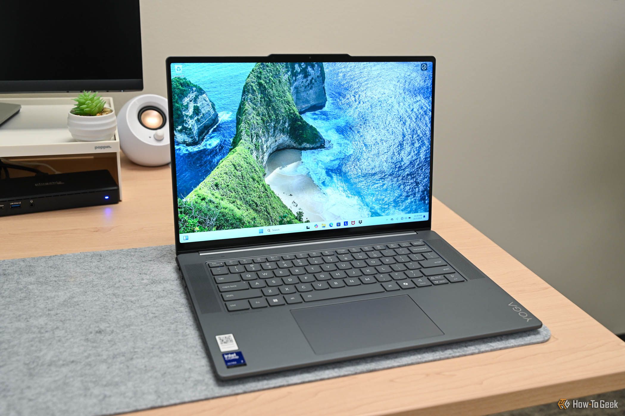 The Lenovo Yoga Slim 7i Aura Edition opened to the Windows 11 home screen.