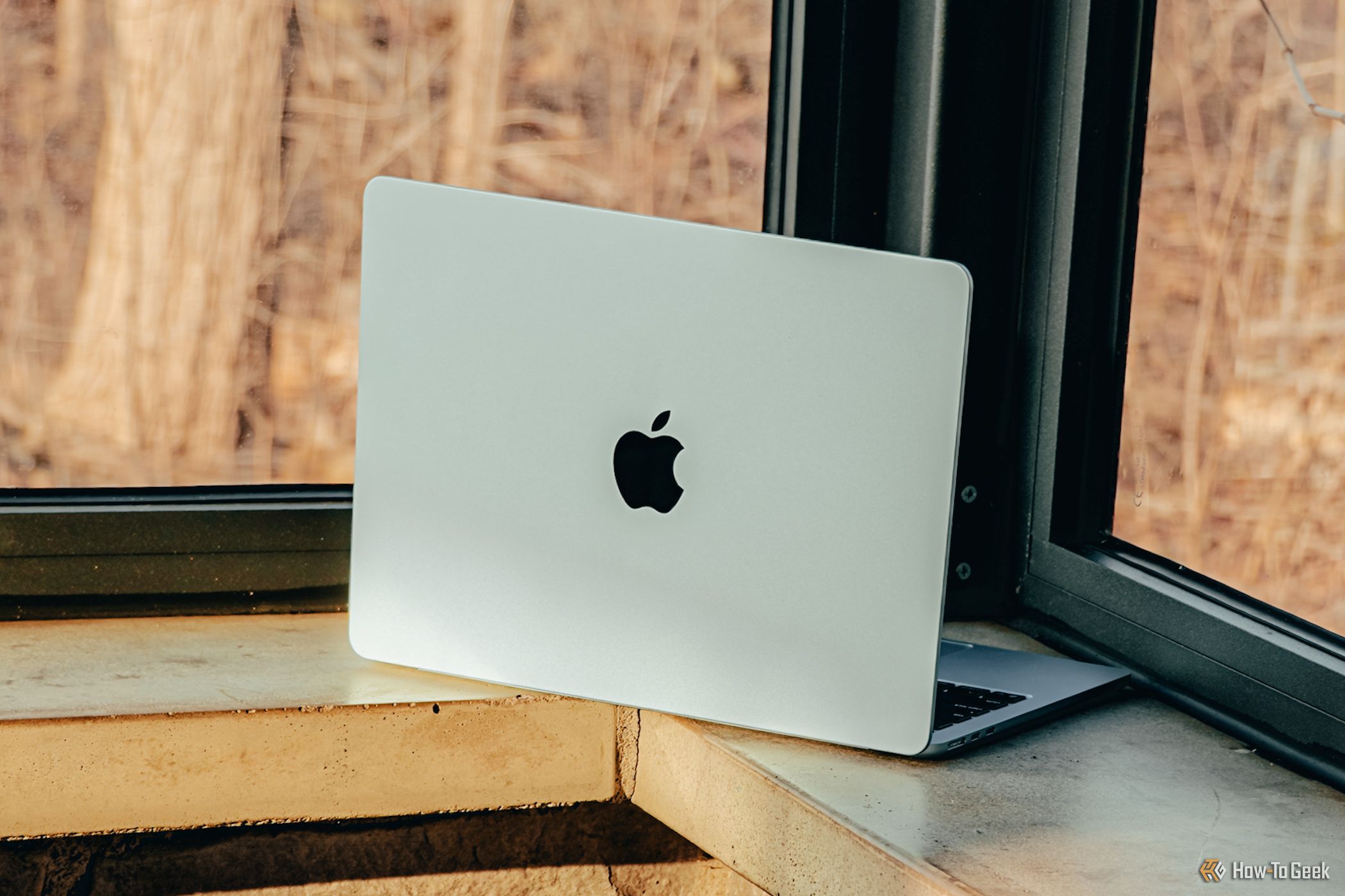 M4 MacBook Air in Sky Blue against ledge.