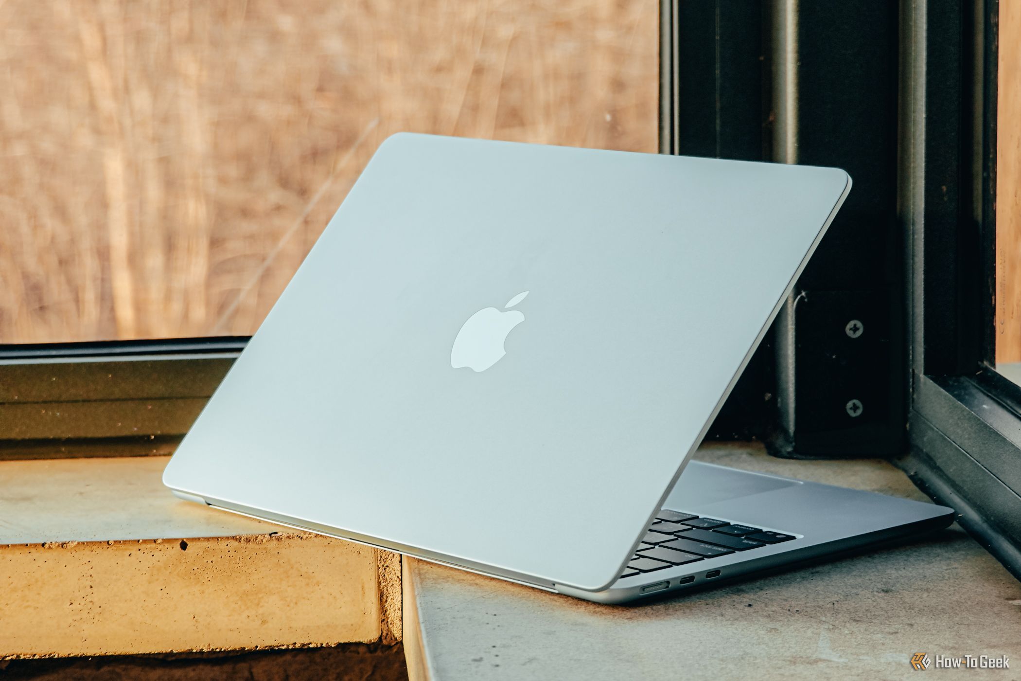 M4 MacBook Air in Sky Blue angled on ledge.