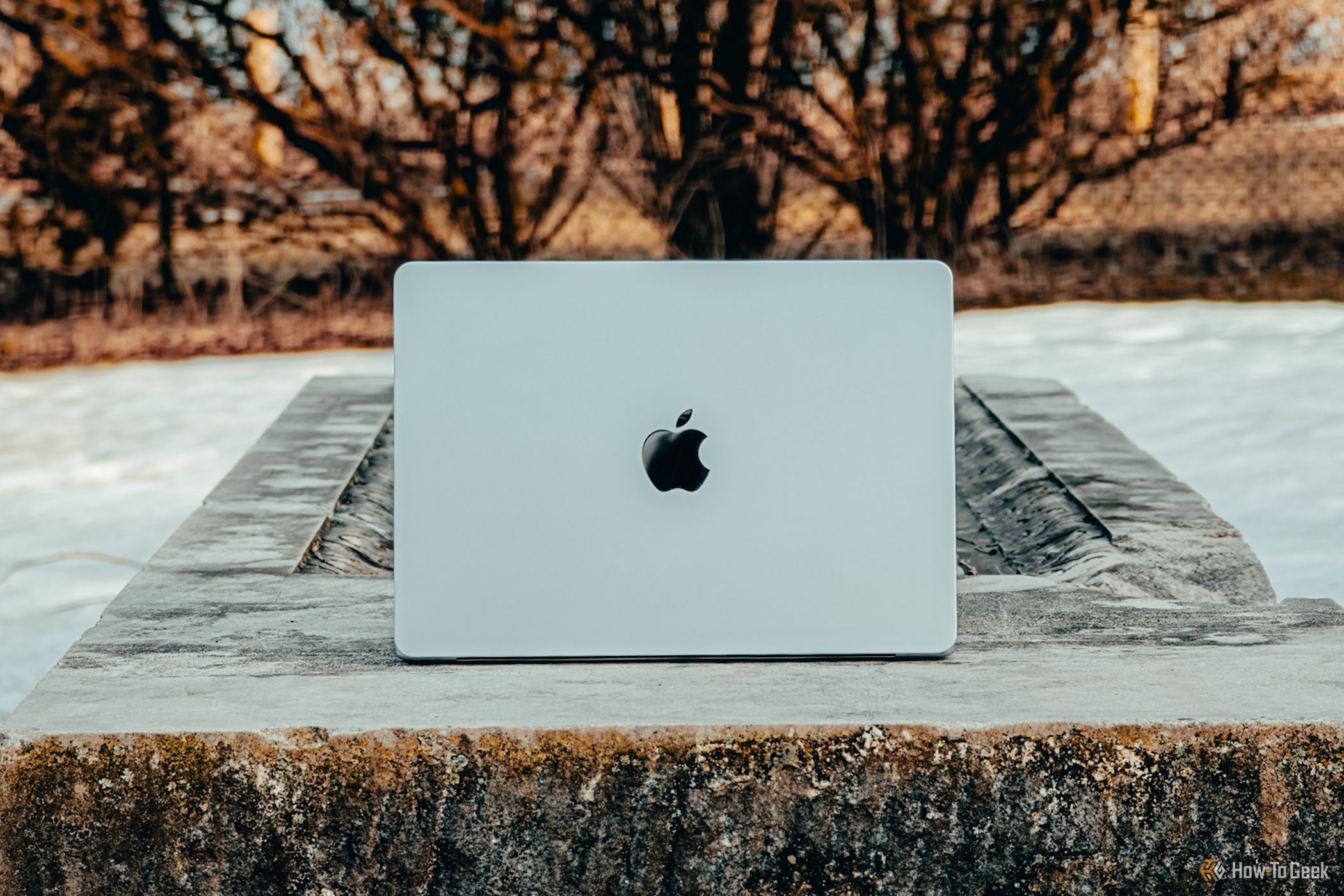 M4 MacBook Air in Sky Blue lid head on on concrete bench.