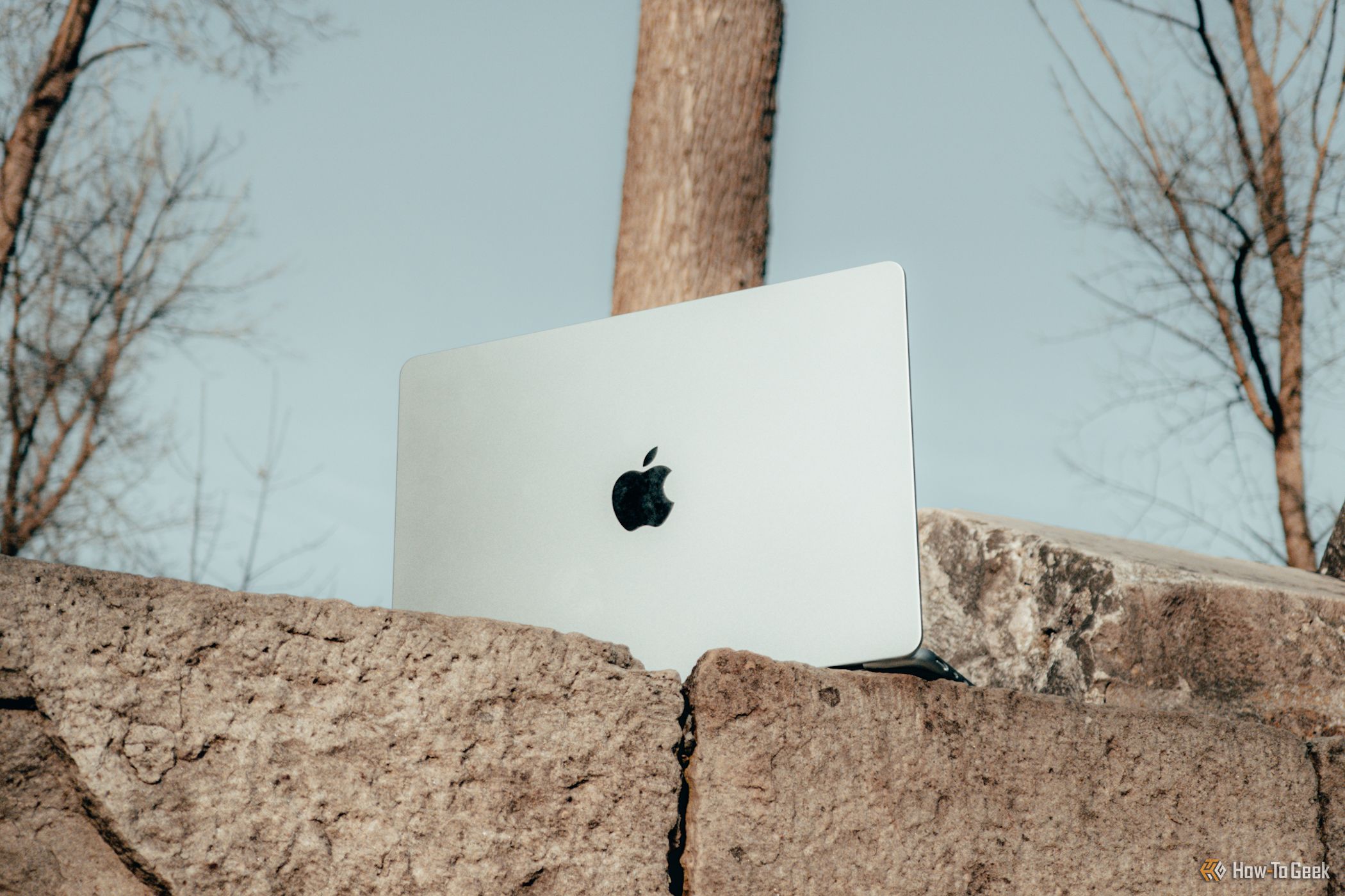 M4 MacBook Air in Sky Blue on concrete bricks.