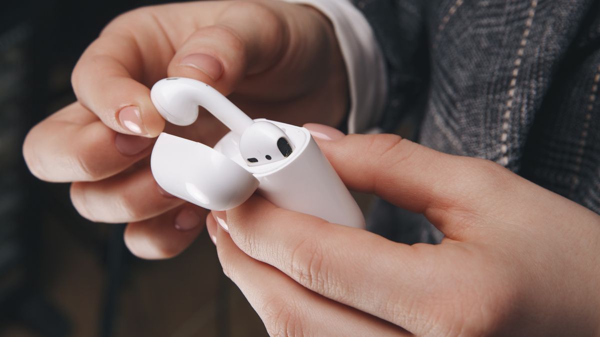 Person pulling AirPods out of their case